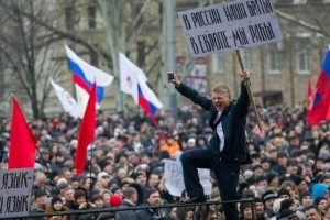 Manifestante Pro-Russia a Donetsk con un cartello che dice: "In Russia abbiamo fratelli, in Europa siamo schiavi". 